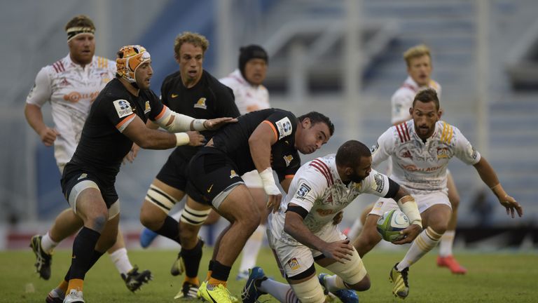 Chiefs No 8 Michael Leitch (second right) is tackled by Jaguares hooker Agustin Creevy