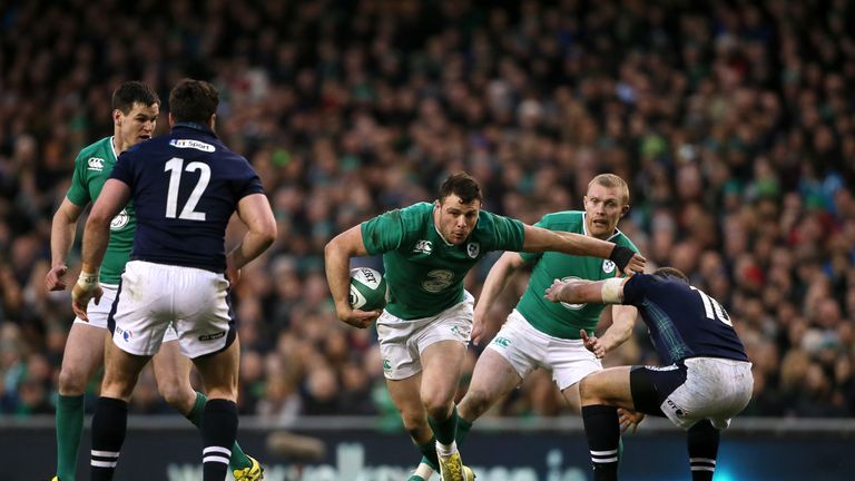 Ireland's Robbie Henshaw (centre) evades a tackle from Scotland's Duncan Weir (right)