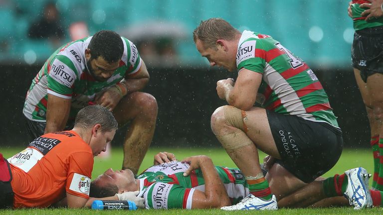 SYDNEY, AUSTRALIA - MARCH 20: Greg Inglis (L) and  Jason Clark (R) of the Rabbitohs show thier concern as Sam Burgess of the Rabbitohs receives attention f