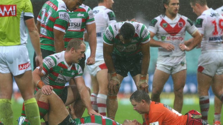 Sam Burgess of the Rabbitohs lays on the ground injured 