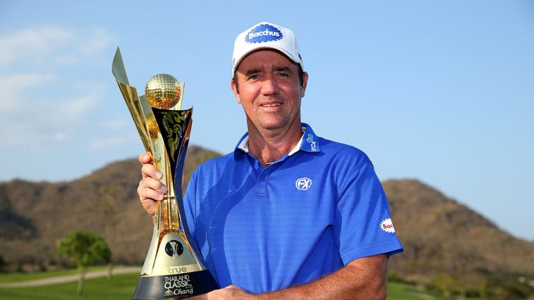 Scott Hend of Australia celebrates with the trophy after claiming victory at the Thailand Classic at Black Mountain Golf Club