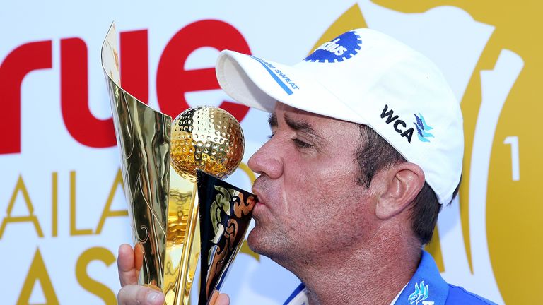 Scott Hend of Australia celebrates with the trophy after claiming victory at the True Thailand Classic