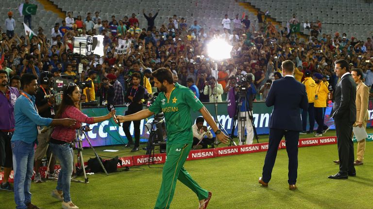 Shahid Afridi walks away after being interviewed, following the Australia T20 game