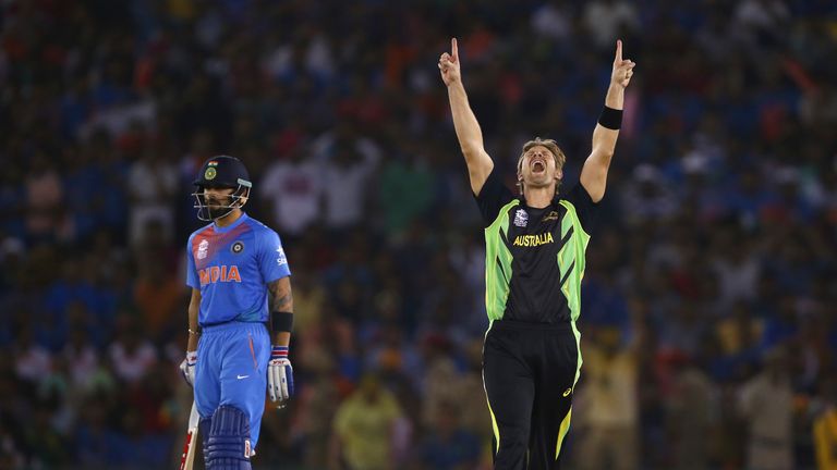 Shane Watson of Australia celebrates after taking the wicket of Rohit Sharma of India as Virat Kohli of India looks on