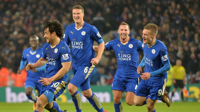 Leicester City's Japanese footballer Shinji Okazaki (L) celebrates after scoring his team's first goal