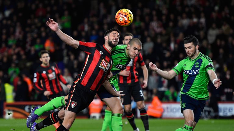 Simon Francis of Bournemouth and Southampton's Oriol Romeu compete for the ball