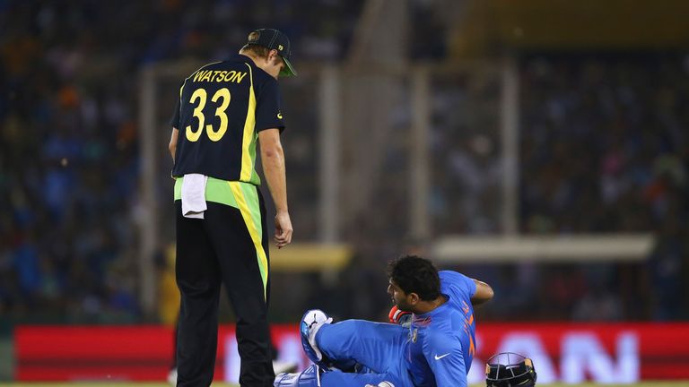 MOHALI, INDIA - MARCH 27:  Yuvraj Singh of India injuires his ankle as Shane Watson of Australia look