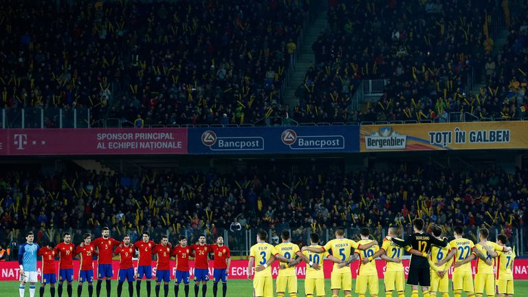 The teams of Spain and Romania stop for a minute's silence to remember Johan Cruyff of Netherlands prior to the Internati