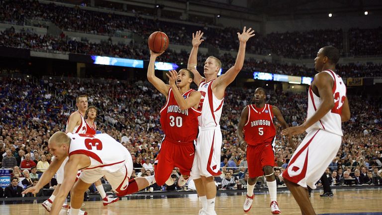 Stephen Curry #30 of the Davidson Wildcats drives for a shot attempt against Greg Stiemsma #34 and Joe Krabbenhoft #45 of the Wisconsi