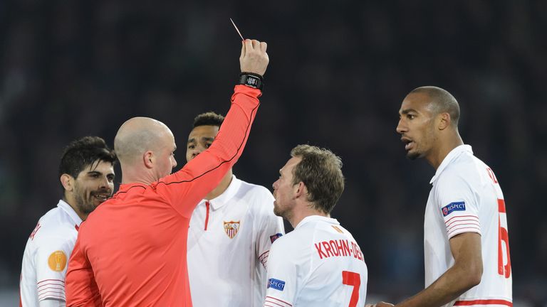 Referee Anthony Taylor shows a red card to Sevilla's French midfielder Steven N'Zonzi 