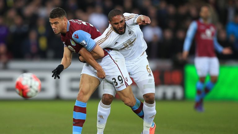 Rudy Gestede and Ashley Williams compete for the ball