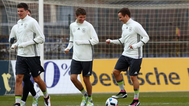  Thomas Mueller (C) of Germany and team mate Mario Goetze (R) run with the ball during a Germany training session