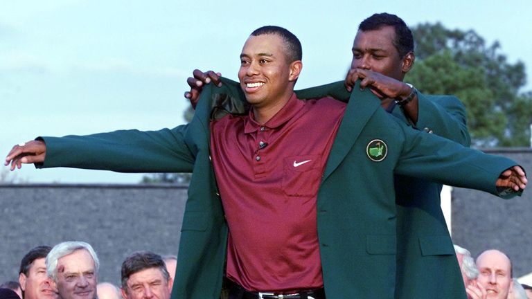 Tiger Woods was presented the jacket by 2000 champion Vijay Singh