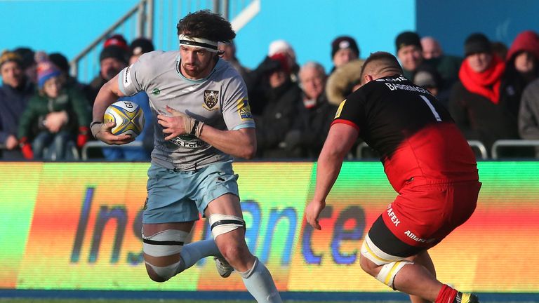 Tom Wood of Northampton is tackled by Richard Barrington during the Aviva Premiership match between Saracens and Northampton Saints at Allianz Park