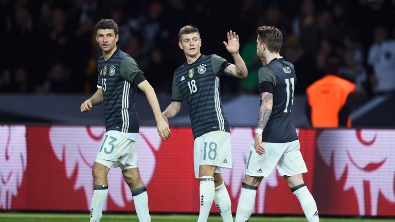 Toni Kroos (C) of Germany celebrates scoring his team's first goal with his team mate Thomas Muller and Marco Reus