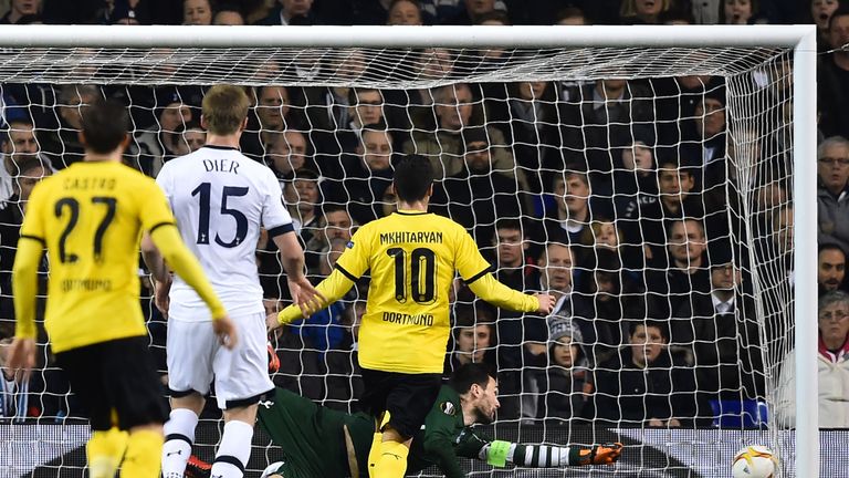 Tottenham Hotspur's French goalkeeper Hugo Lloris dives but cannot prevent the shot from Borussia Dortmund's Gabonese striker Pierre-Emerick Aubameyang