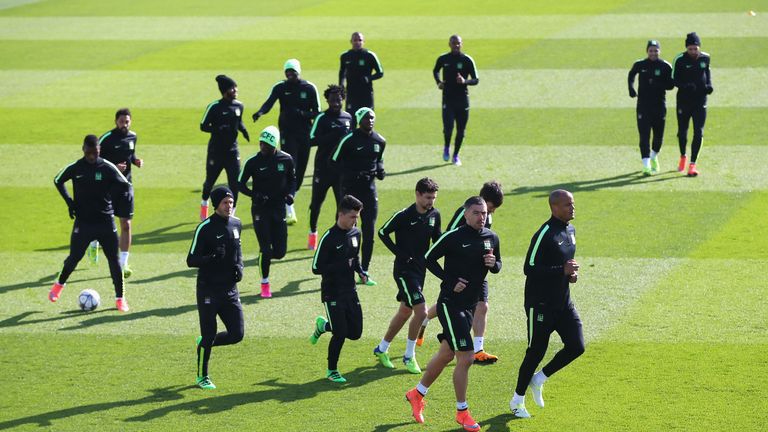 Vincent Kompany of Manchester City leads his players in the warm up during a training session
