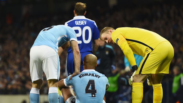 MANCHESTER, ENGLAND - MARCH 15:  An injured Vincent Kompany of Manchester City (4) in discussion with team mates Pablo Zabaleta (L) and Joe Hart (R)  durin