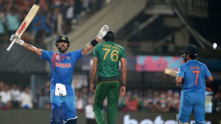 India's Virat Kohli (L) celebrates with captain Mahendra Singh Dhoni