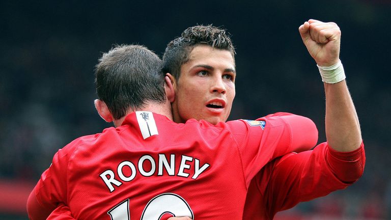 Manchester United's Portuguese forward Cristiano Ronaldo (R) and Wayne Rooney celebrate Ronaldo's second goal after scoring the third  goal against WIgan A