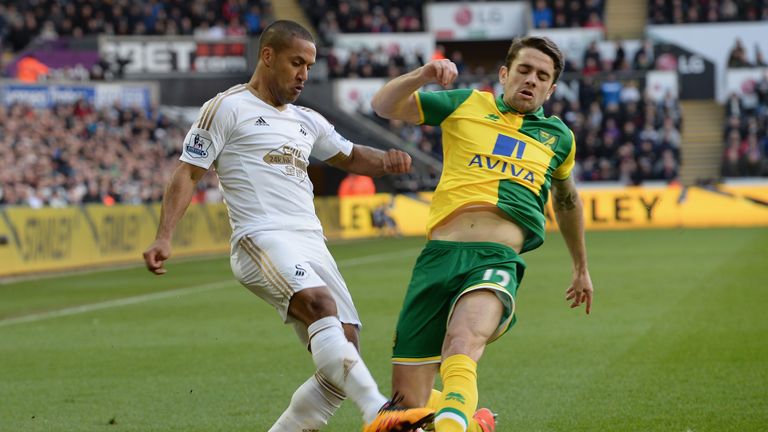Wayne Routledge is tackled by Robbie Brady 