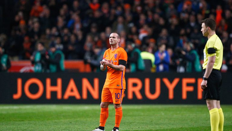 Wesley Sneijder of the Netherlands stands in the 14th minute for a minute's silence