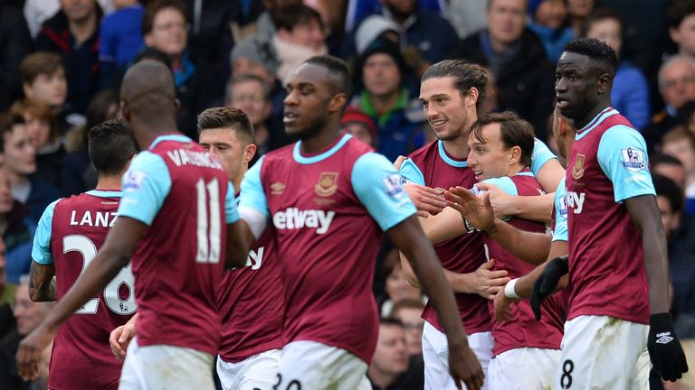 Andy Carroll celebrates with his team-mates after scoring with his first touch