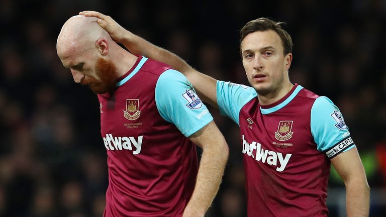 James Collins is consoled by Mark Noble after going off against Spurs