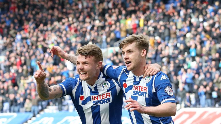 Wigan Athletic's Conor McAleny (right) celebrates scoring  against Rochdale