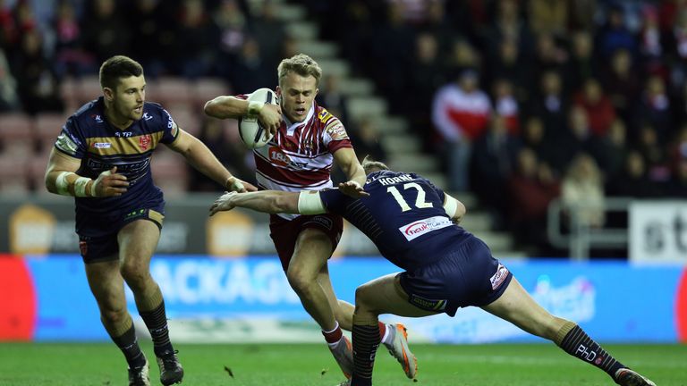Wigan Warriors Lewis Tierney is tackled by Hull Kingston Rovers' Graeme Horne (right) and Mitchell Allgood (left), during the First Utility Super League ma