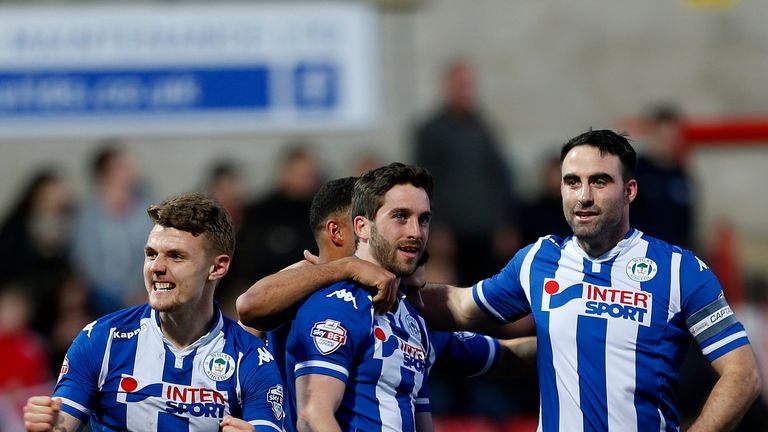 Wigan Athletic's Will Grigg (centre) celebrates scoring his side's third goal of the game against Swindon