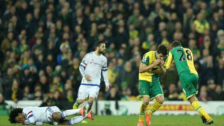 Chelsea's Willian (left) lies on the ground after colliding with Norwich City's Robbie Brady (centre) and Gary O'Neil during the Barclays Premier League ma