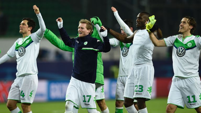 Wolfsburg's striker Andre Schuerrle (c) and teammates react after their 1-0 victory