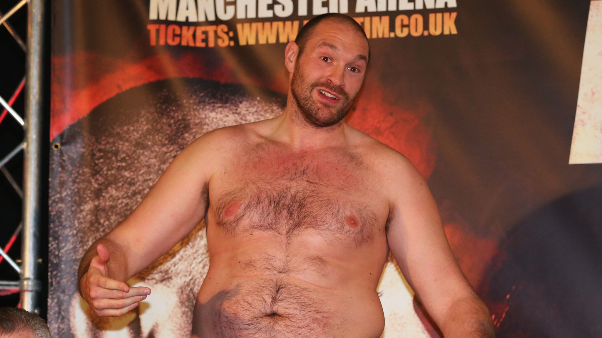 Tyson Fury speaks after removing his shirt. 