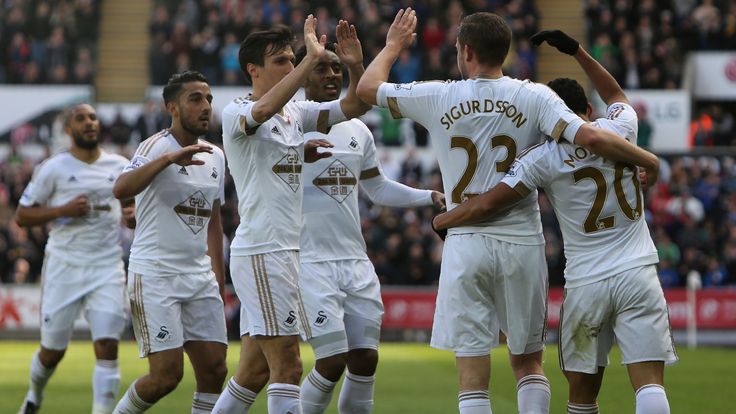 Swansea City's Icelandic midfielder Gylfi Sigurdsson celebrates scoring his team's first goal against Chelsea