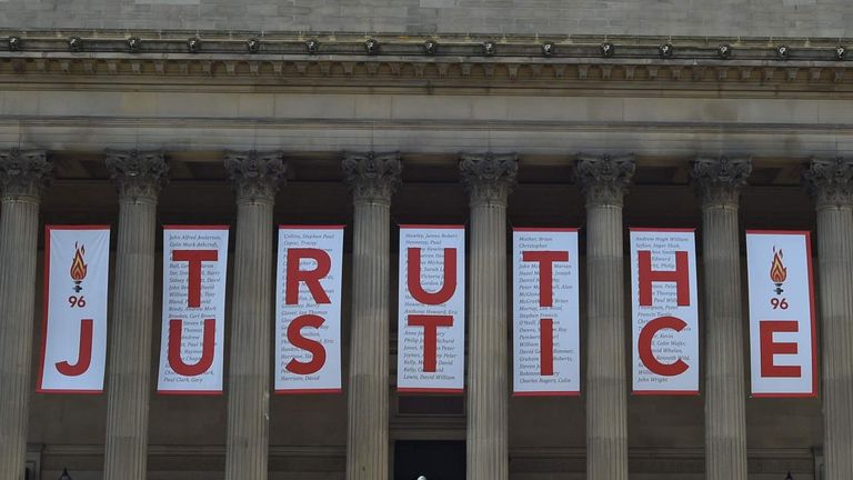 A giant banner is unveiled at St George's Hall in Liverpool after the Hillsborough inquest concludes