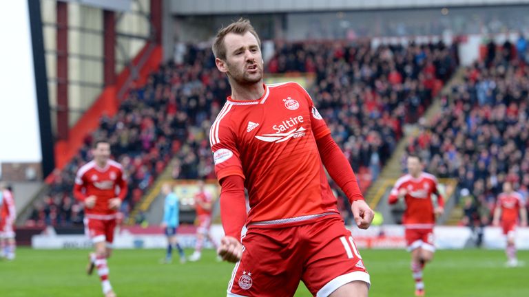 McGinn celebrates his goal in a one-sided contest at Pittodrie