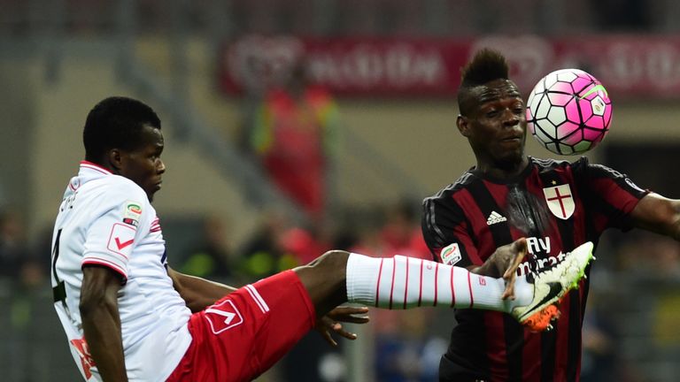 AC Milan's forward from Italy Mario Balotelli (R) fights for the ball with Carpi's midfielder Isaac Cofie 