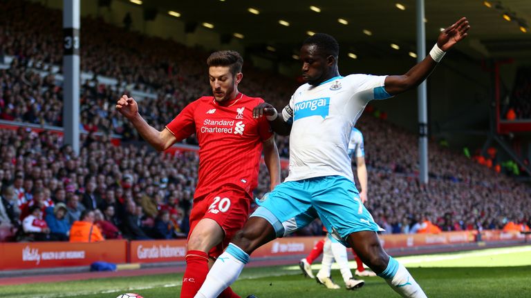 LIVERPOOL, ENGLAND - APRIL 23:  Moussa Sissoko of Newcastle United makes a challenge on Adam Lallana of Liverpool during the Barclays Premier League match 
