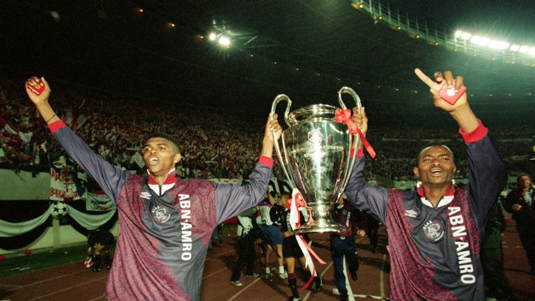 Ajax duo Nwankwo Kanu and Finidi George celebrate with the Champions League trophy after beating AC Milan in 1995