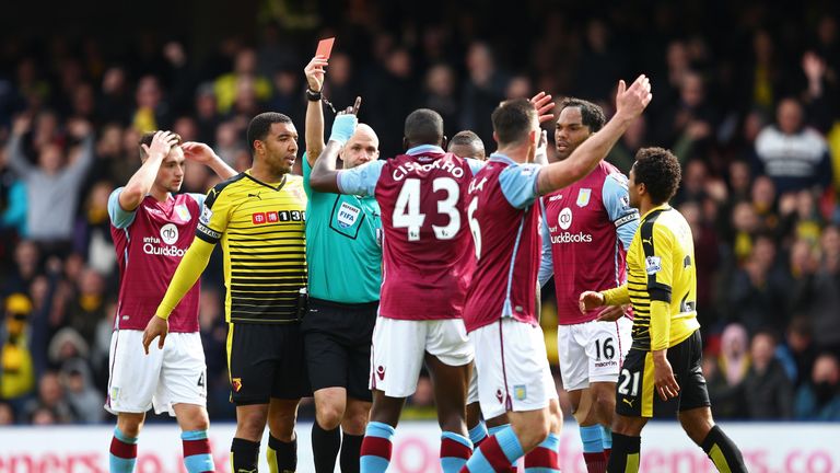 Aly Cissokho of Aston Villa is shown a red card by referee Anthony Taylor during the Premier League match at Watford