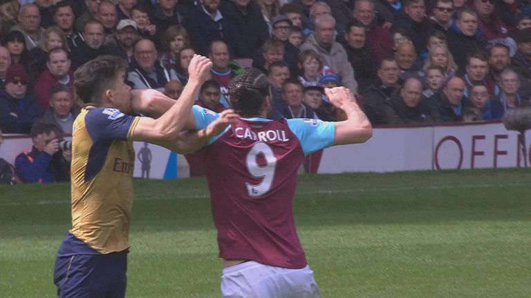 Andy Carroll catches Gabriel with an elbow durign West Ham's Premier League game with Arsenal at Upton Park.