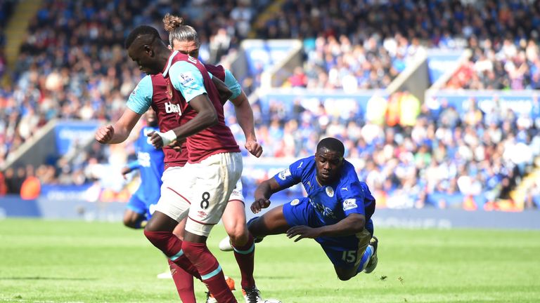 Leicester's Jeff Schlupp falls down under the attempted challenge from Andy Carroll