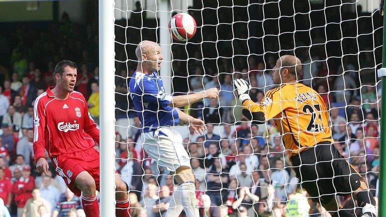 Everton's Andy Johnson puts the ball past Liverpool's goalkeeper Jose Reina during the Premier League match as Jamie Carragher looks on