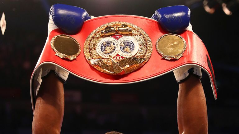 Anthony Joshua of England celebrates with the belt after defeating Charles Martin of the United States