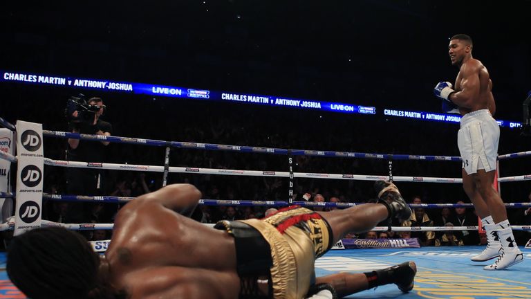 Anthony Joshua (right) knocks down Charles Martin during the IBF Heavyweight World Championship title bout at the 02 Arena