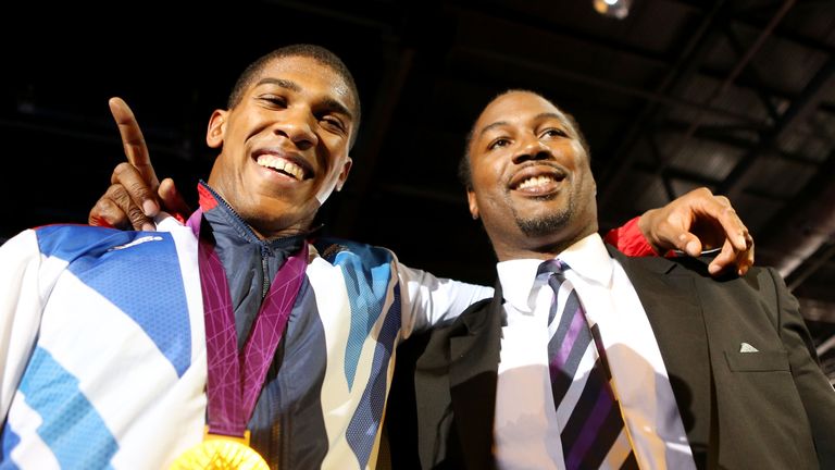 Gold medalist Anthony Joshua (L) of Great Britain celebrates with former world heavweight boxing champion and fellow countrym