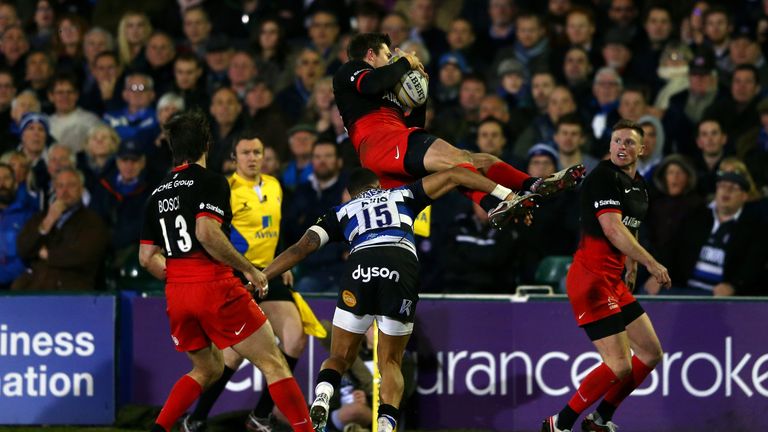 Alex Goode of Saracens is tackled in the air by Anthony Watson resulting in a red card for the Bath full-back