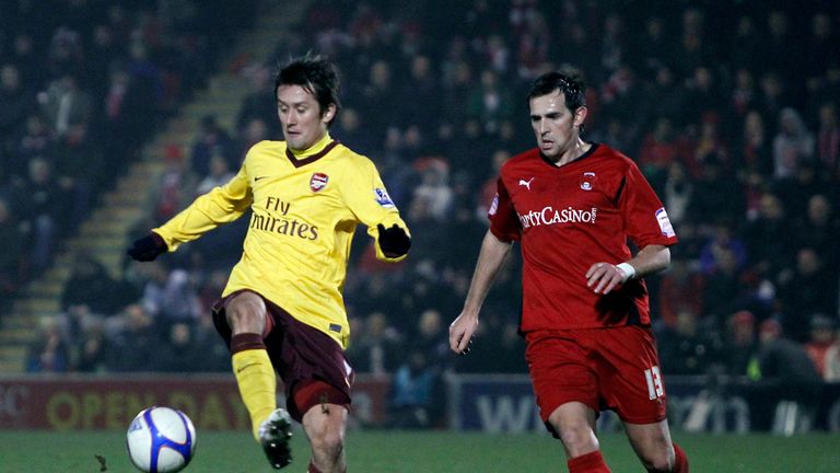 Arsenal's Czech Tomas Rosicky (L) vies with Leyton Orient's Charlie Daniels (R) during their FA Cup fifth round football match at Brisbane Road in 2011