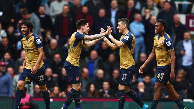 Mesut Ozil (2nd R) of Arsenal celebrates scoring his team's first goal with his team mate Hector Bellerin (2nd L) during Arsenal v West Ham on April 9